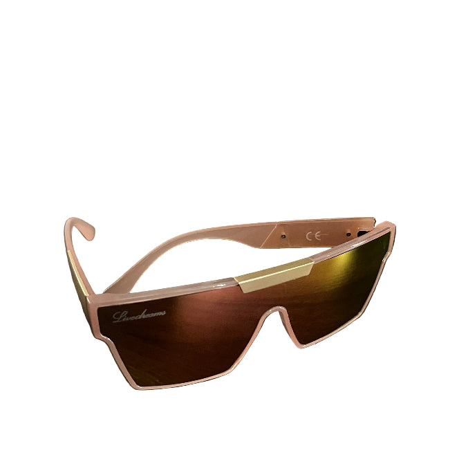 A pair of oversized shield-style sunglasses with a translucent pink frame and mirrored lenses, resting on a dark wooden table.