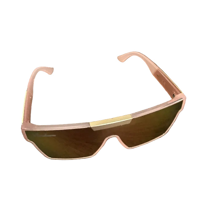 A pair of shield-style sunglasses with a translucent pink frame and mirrored green-tinted lenses, resting on a dark wood tabletop.