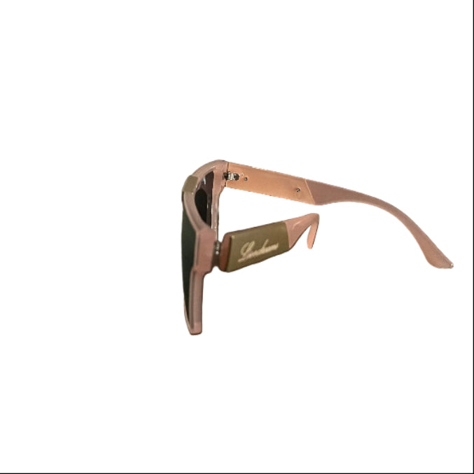 A pair of light pink sunglasses with dark lenses resting on a dark wooden table, with a neutral indoor background showing a wall and door.